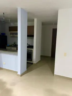 an empty living room with a stove and a kitchen at Apartamento en villa campestre Barranquilla in Barranquilla