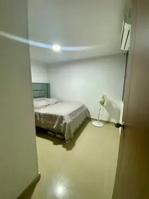 a room with a bed and a lamp in it at Apartamento en villa campestre Barranquilla in Barranquilla