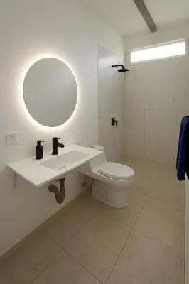 a bathroom with a sink and a toilet with a mirror at Apartaestudio en Tierra Bomba in Isla de Tierra Bomba