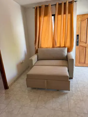 a couch in a living room with orange curtains at Apto emperatriz house in Cartagena de Indias