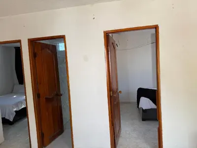 a room with two doors and a room with a bed at Apto emperatriz house in Cartagena de Indias