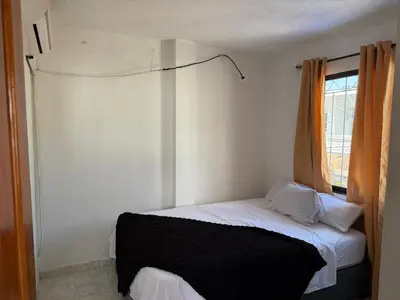 a small bedroom with a bed with a window at Emperatriz I in Cartagena de Indias
