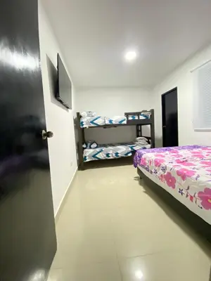 a room with a bed and two bunk beds at Apartamento BBB para 4 pax en La Boquilla in Cartagena de Indias