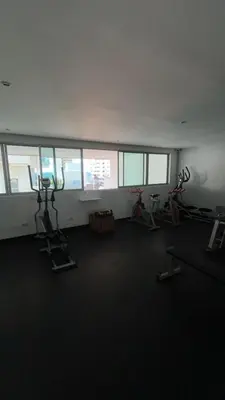 a gym with several exercise bikes in a room with windows at Apartamento en Cartagena Marbella in Cartagena de Indias