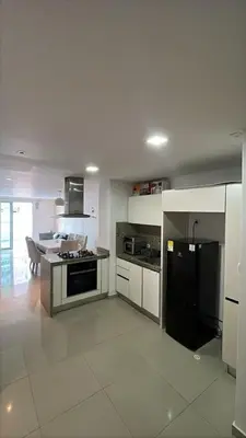 a kitchen with a black refrigerator and a stove at Apartamento en Cartagena Marbella in Cartagena de Indias
