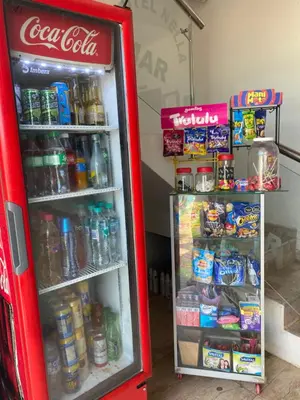 a red cocacola refrigerator with its door open with drinks at Hotel Nellamar in Puerto Colombia