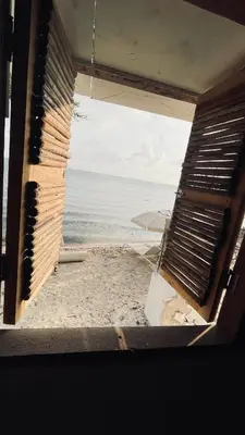 an open window with a view of the ocean at Puerto idilio beach resort in Isla Grande