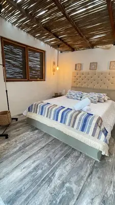 a bedroom with a bed and a wooden floor at Puerto idilio beach resort in Isla Grande