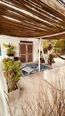 a patio of a house with a table and chairs at Puerto idilio beach resort in Isla Grande