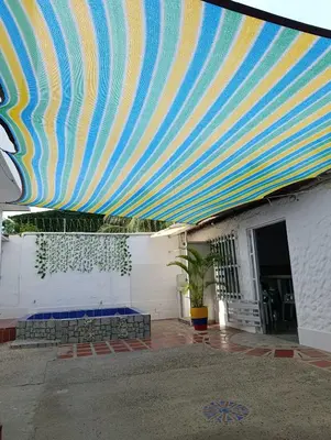 a large blue and yellow striped canopy over a building at Apartamentos en Sabanilla, Colombia -Tu Escapada Ideal! in Maizal