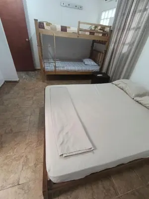 a bedroom with a bed with a blanket on it at Apartamentos en Sabanilla, Colombia -Tu Escapada Ideal! in Maizal