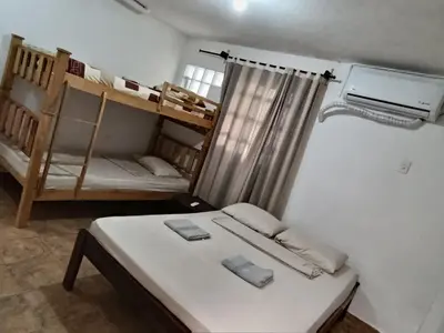 a room with a bed and bunk beds in it at Apartamentos en Sabanilla, Colombia -Tu Escapada Ideal! in Maizal