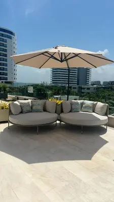 two white couches sitting under an umbrella at CARTAGENA BEACHT - APARTAESTUDIO A 100 mt del mar - Piscina, Jacuzzi in Cartagena de Indias