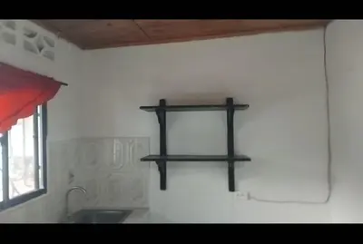 a kitchen with a sink and a shelf on the wall at Hospedaje el Floral in Tolú