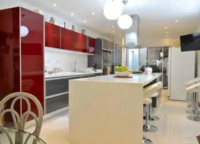a kitchen with red cabinets and a white counter top at Great Apartment With Private Pool in Cartagena de Indias