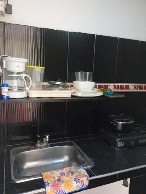 a kitchen with a sink and a counter with dishes at La Escalera de Getsemani in Cartagena de Indias