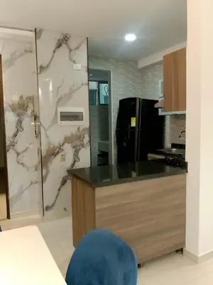 a kitchen with a counter and a refrigerator at Apartamento de 3 habitaciones, al norte de Barranquilla, via a Cartagena, aire acondicionado en sala y todas las habitaciones, excelenten para trabajo o descanso in Barranquilla