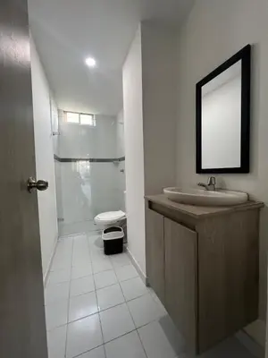 a bathroom with a sink and a toilet and a mirror at Apto Familiar Moderno Cerca de Todo en Coveñas in Coveñas