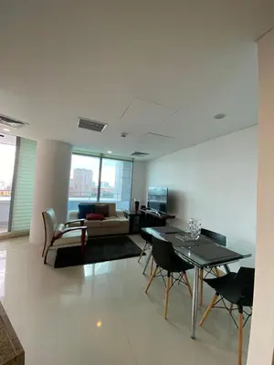a living room with a couch and a table and chairs at Blue Gardens in Barranquilla