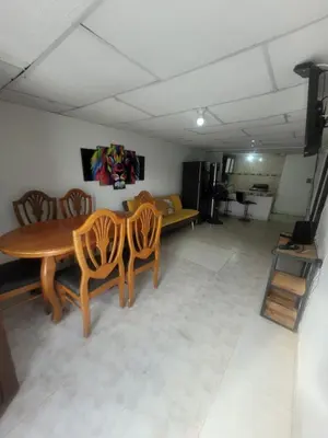 a living room with a wooden table and chairs at Julius cartagena in Cartagena de Indias