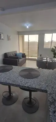 a living room with a table and a couch at Apartamento Cartagena Tranquilo playa-piscina in Manzanillo del Mar