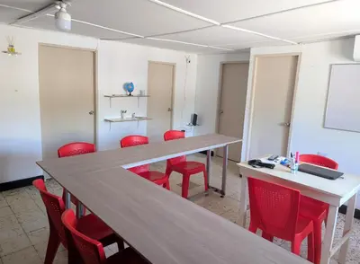 a conference room with red chairs and a long table at Central Point Air BAQ in Barranquilla