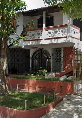 a house with a gate in front of it at Central Point Air BAQ in Barranquilla