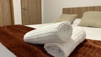 a pile of towels sitting on top of a bed at Sofia del Mar in Puerto Colombia