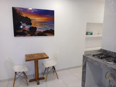 a kitchen with a table and chairs and a painting on the wall at Apartasuite Marbella in Cartagena de Indias