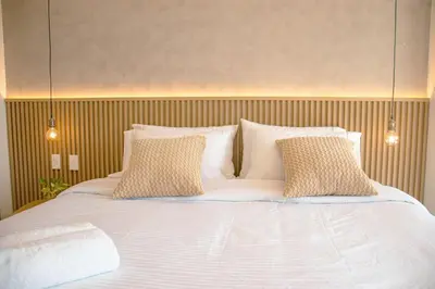 a large bed with white sheets and pillows at Morros Serena del Mar in Cartagena de Indias