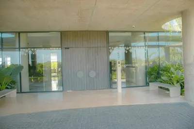 a lobby of a building with glass doors and plants at Morros Serena del Mar in Cartagena de Indias