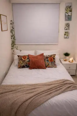 a bedroom with a white bed with pillows at Apartaestudio Económico en Cartagena, al lado de la Playa in Cartagena de Indias