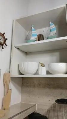 a white shelf with bowls and boats on it at Mararena in Coveñas