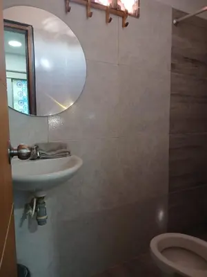a bathroom with a sink and a mirror and a toilet at Mararena in Coveñas