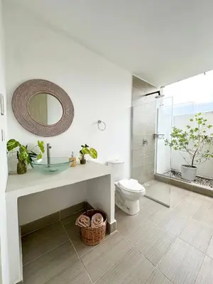 a bathroom with a sink and a toilet and a mirror at Villa in Sabanilla near the Sea in Maizal