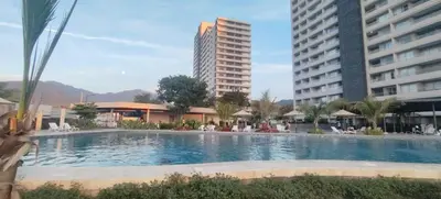 a swimming pool in the middle of two buildings at Santa marina in Santa Marta
