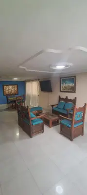 a living room with chairs and a couch and a television at Tourist apartment steps from the Historic Center in Cartagena de Indias