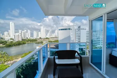 a balcony with a chair and a view of the city at Marèlago Apartamentos in Cartagena de Indias
