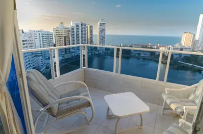 a balcony with chairs and a view of the ocean at Marèlago Apartamentos in Cartagena de Indias