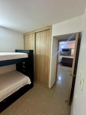 a room with two bunk beds and a sliding door at Apartamento moderno in Cartagena de Indias