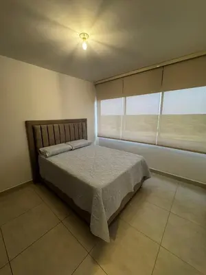 a bedroom with a bed and a large window at Sensacional Apartamento Serena del Mar in Serena del Mar