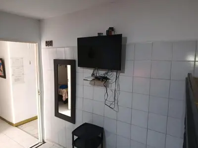 a television hanging on a wall with a mirror at Hostal Mastcoy in Cartagena de Indias