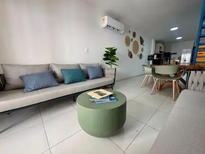 a living room with a couch and a table at Cozy duplex at Cartagena City Center in Cartagena de Indias