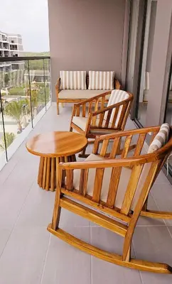 two wooden chairs and a table on a balcony at APARTAMENTO MORROS EOS y ECO VISTA AL MAR in Cartagena de Indias