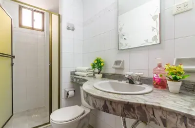 a white bathroom with a sink and a toilet at Guest bedrooms economy in Bocagrande Beach Cartagena in Cartagena de Indias