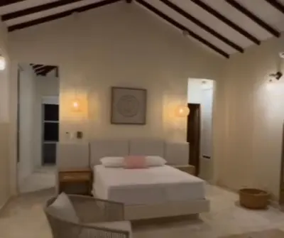a bedroom with a white bed and a chair at Casa Azure Playas del Francés in El Puertón