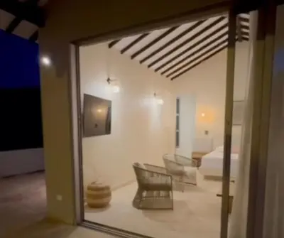 a view of a living room with a bed and chairs at Casa Azure Playas del Francés in El Puertón