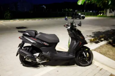 a motor scooter parked in a parking lot at Aguita de coco in Cartagena de Indias