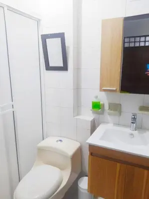 a white bathroom with a toilet and a sink at tranquilo alojamiento centro cartagena in Cartagena de Indias