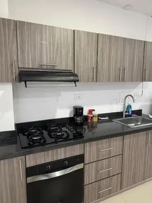 a kitchen with a black stove and a sink at Modern apartment in Boston, Sincelejo in Sincelejo